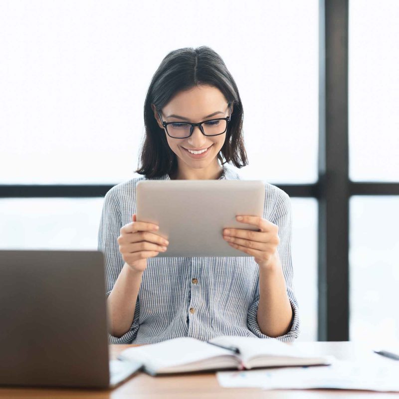 young girl holding tablet and using laptop at offi uf2udk6 800x800 1.jpg
